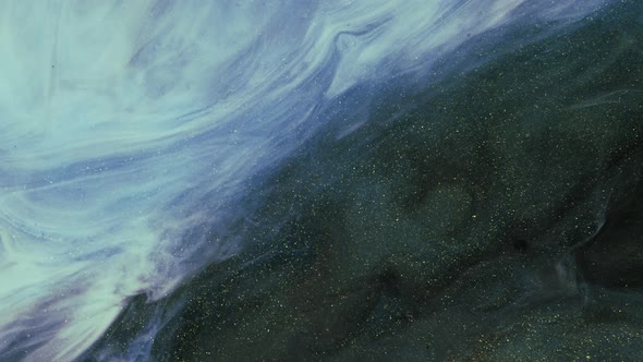 Beautiful Golden Shimmering Particles in White Smoke on a Black Background alt