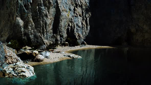 Beach Coast of the Norwegian Sea with Mountains and Cliffs on Sunny Day alt