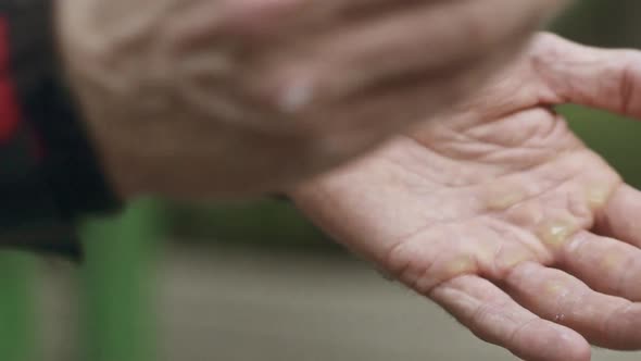 A Couple of Manly Hands Putting on Talc Powder alt