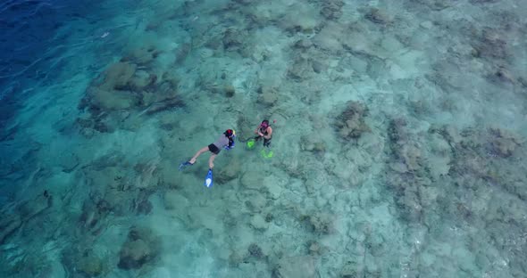 Romantic man and woman married on vacation have fun on beach on clean white sand background alt