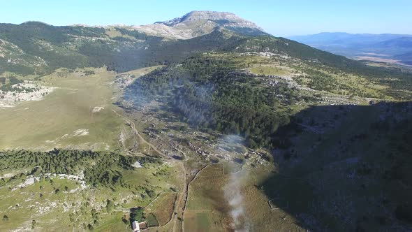 Bushes burning on Dinara mountain alt