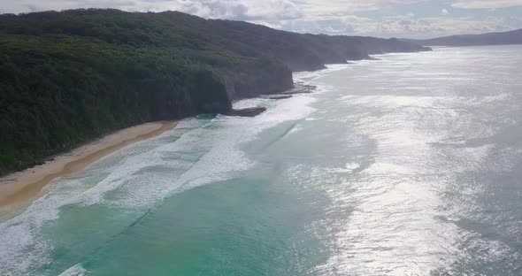 Spectacular aerial morning flight over wild colorful ocean and cliffs, Australia alt