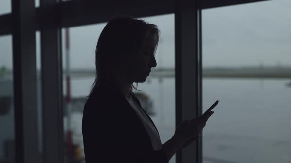 Silhouettes of a Young Woman at the Airport alt