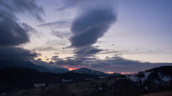 Beautiful dusk over the mountain landscape, day to night. Beautiful colors of clouds alt