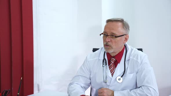 Doctor explaining for patient at hospital. Male doctor discussing with patient in clinic alt