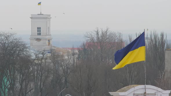 Flag of Ukraine flutters upon annex Crimea. Occupied Crimea territory. Russian invasion of Crimea. alt
