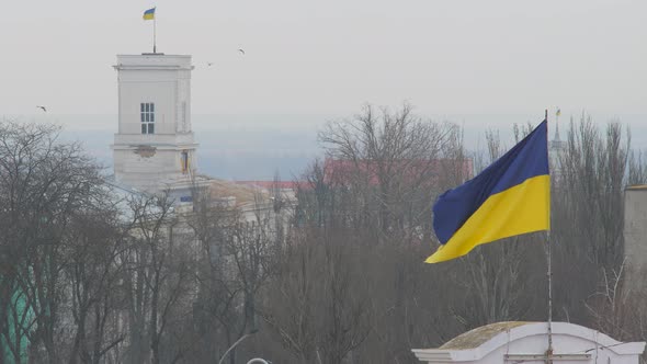 Flag of Ukraine flutters upon annex Crimea. Occupied Crimea territory. Russian invasion of Crimea.