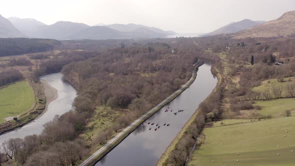 A Group of Canoeists Travelling Along a Canal alt