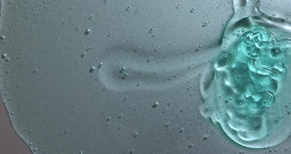 Blue cream liquid gel serum pours on silver texture, makeup alt