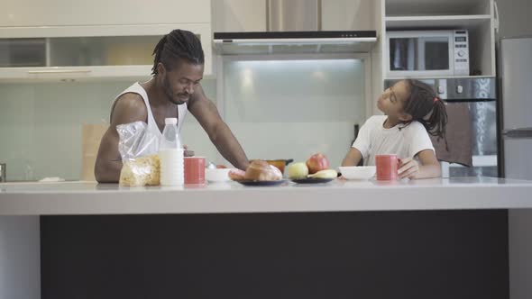 Wide Shot Happy Relaxed African American Father Daughter Having Breakfast Kitchen Home alt