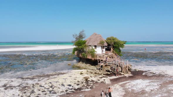 The Rock Restaurant in Ocean Built on Cliff at Low Tide on Zanzibar Aerial View alt