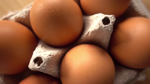 close up of brown eggs in egg carton on rustic background alt