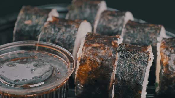 Japanese Sushi Rolls in Plastic Box is Rotating alt