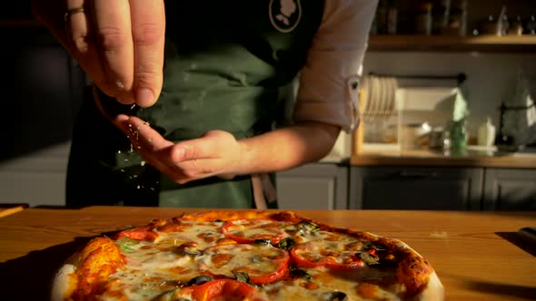 Final Touch at Flavoring Freshly Baked Pizza