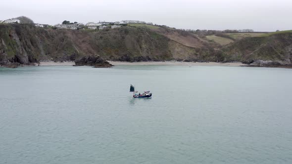 Fishing Boat Pulling Nets on a Grey Day Aerial Shot alt