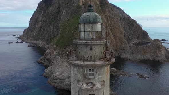 Abandoned Lighthouse Aniva on the Rock in Sakhalin Island, Russia. Drone Shot.
