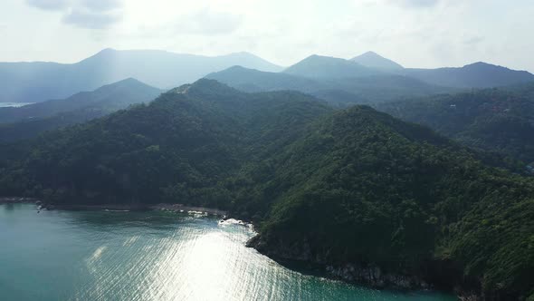 Mistery mountains and sea coast. Sunrays coming out through the heacy clouds. Thailand alt
