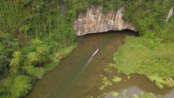 Aerial Shot of Beautiful Limestone Mountains with Passes Carved By a River in Ninh Binh Region a alt