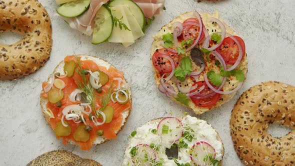 Homemade Bagel Sandwiches with Different Toppings, Salmon, Cottage Cheese, Hummus, Ham, Radish alt