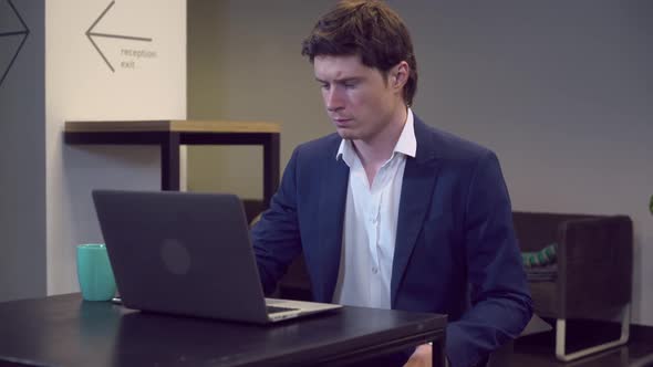 Man Finishing Working Indoors alt