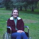 young woman using wheelchair alone in the park smiles at camera - VideoHive Item for Sale