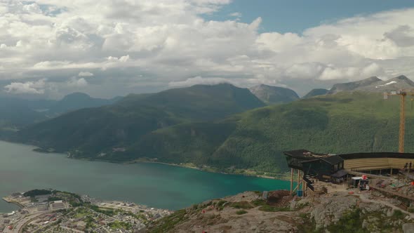Fjord, Andalsnes Town And Green Mountain Range From Eggen Restaurant In Norway. - aerial alt