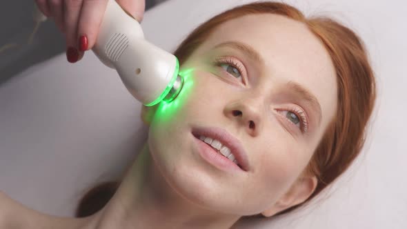 an Attractive Woman in a Cosmetology Clinic Receives a Facial Skin Phonophoresis Procedure