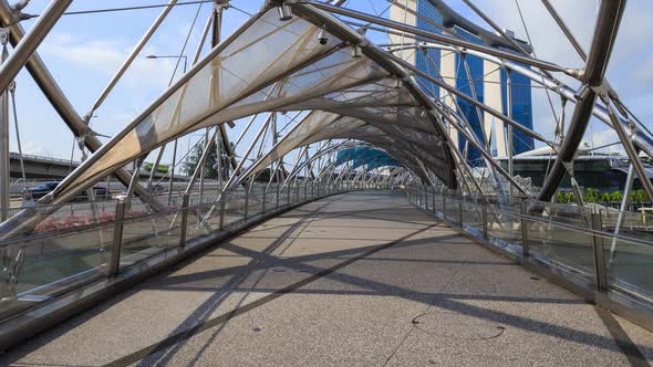 Time-lapse of unidentified tourist and people walking on helix bridge at Marina bay, Singapore alt