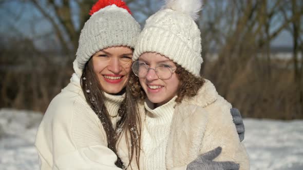 Young Woman and Her Teenage Daughter are Having Fun on a Winter Walk