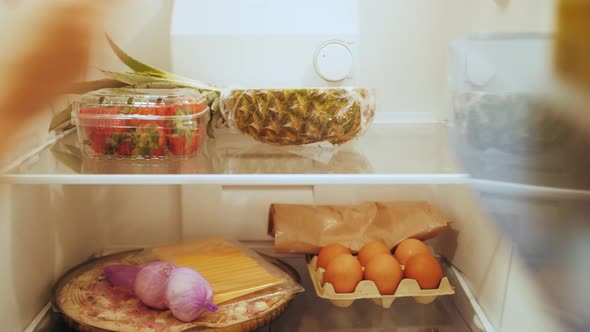 Housewife Unpacking Bag with Groceries Putting Meal in Refrigerator After Shopping on Store alt