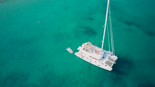 Beautiful beach with yacht top aerial view drone shot