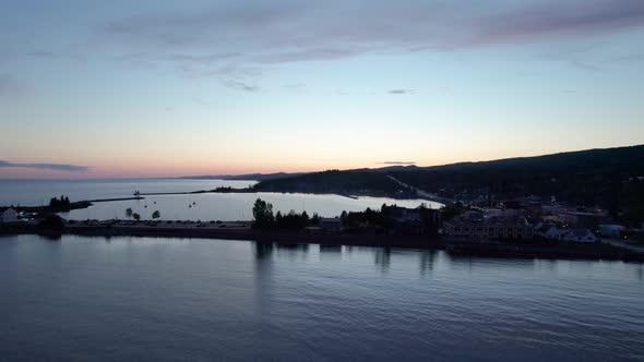 Late evening drone shot over Grand Marais harbor with boats alt