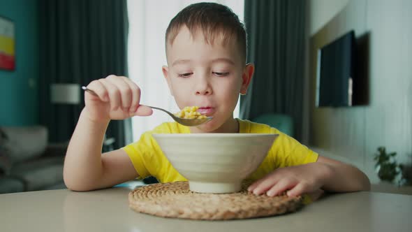 Portrait Little Hungry Child Cute Boy Sits at the Dinner Table Eats Corn Flakes with Milk with an alt