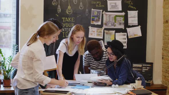 Young Multiethnic Designers Cooperating in the Office