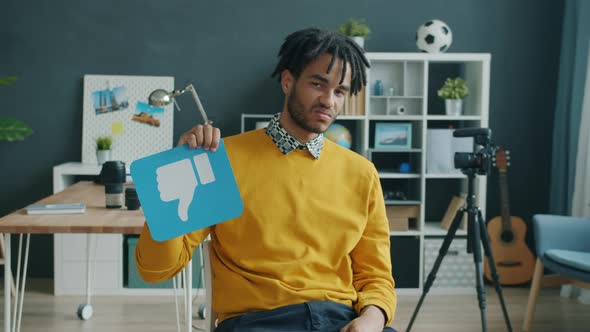 Slow Motion Portrait of African American Blogger Showing Thumbsdown Then Thumbsup Hand Gesture alt