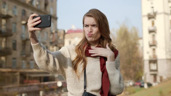 Hipster Girl Taking Selfie Outdoors, Flirting Woman Grimacing for Camera alt