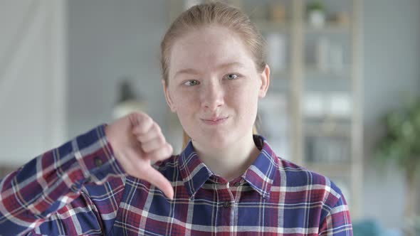 Close Up of Young Woman Doing Thumbs Down alt