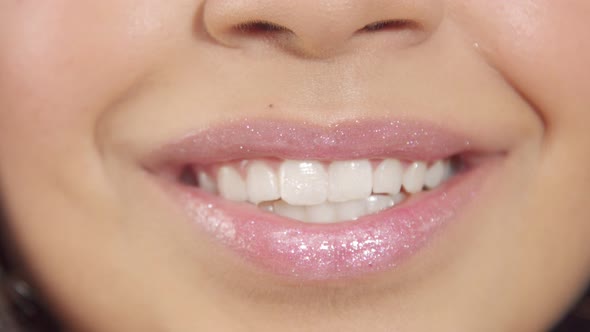 Closeup of Womans Lips with Shiny Lipgloss Smiling