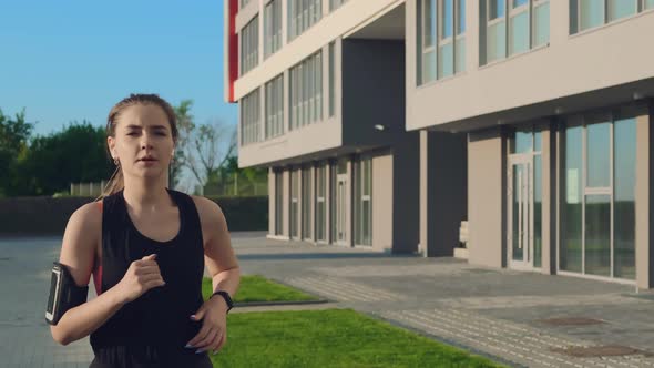 Girl in Black Tracksuit Runs on Street alt