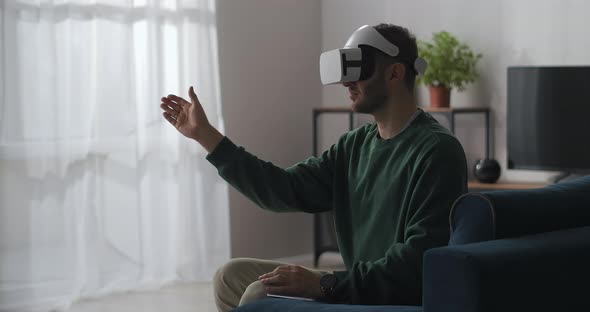 Adult Man with Headmounted Display Is Viewing Virtual Screen and Swiping By Hand Vr Technology alt
