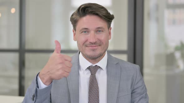 Portrait of Middle Aged Man showing Thumbs Up Sign alt