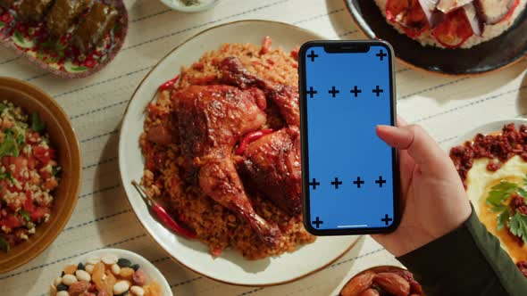 Kabsa Hummus Dolma Maqluba Tabbouleh Closeup Smartphone with Blue Chroma Key Screen Middle Eastern alt