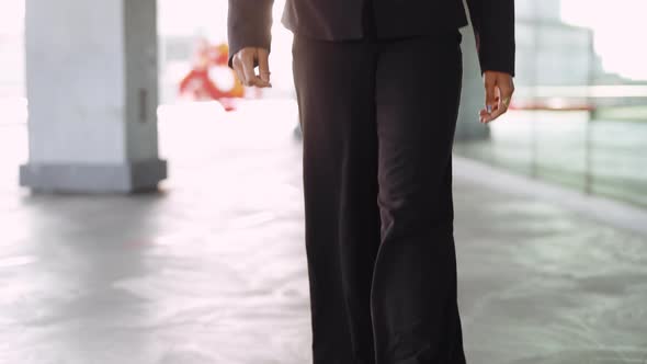 Businesswoman In Black Suit Walking Outside Office alt