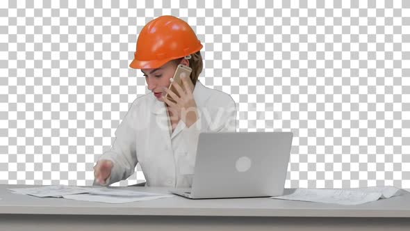 Woman in orange hardhat calling the phone, Alpha Channel