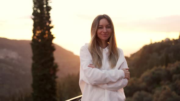 Portrait of a Blonde Woman Enjoying Mountains in Lens Flares alt