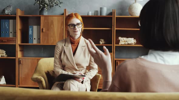 Female Counseling Psychologist Listening Attentively to Woman alt