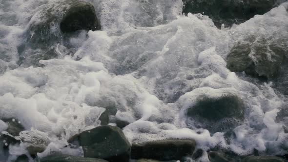 Foam and Bubbles From the Wave on the Stones 