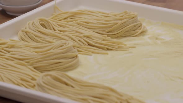 Fresh pasta on tray in the kitchen of an upscale restaurant alt