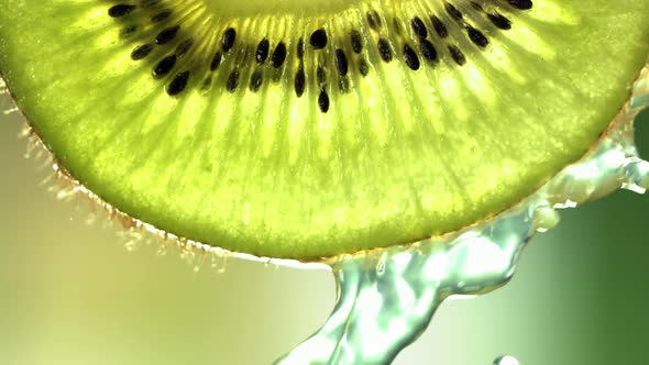 Super Slow Motion Macro Shot of Flowing Water From Kiwi Slice at 500Fps alt