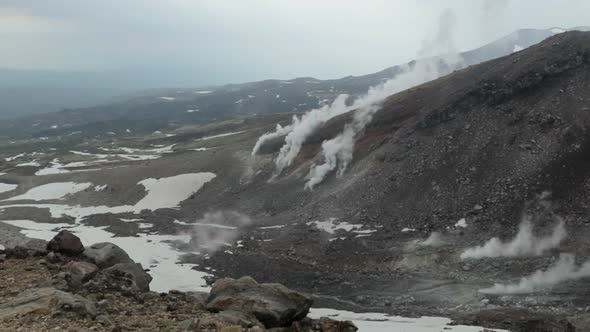 Smoke emerges from slopes of active stratovolcano Asahi-Dake in Japan, static alt